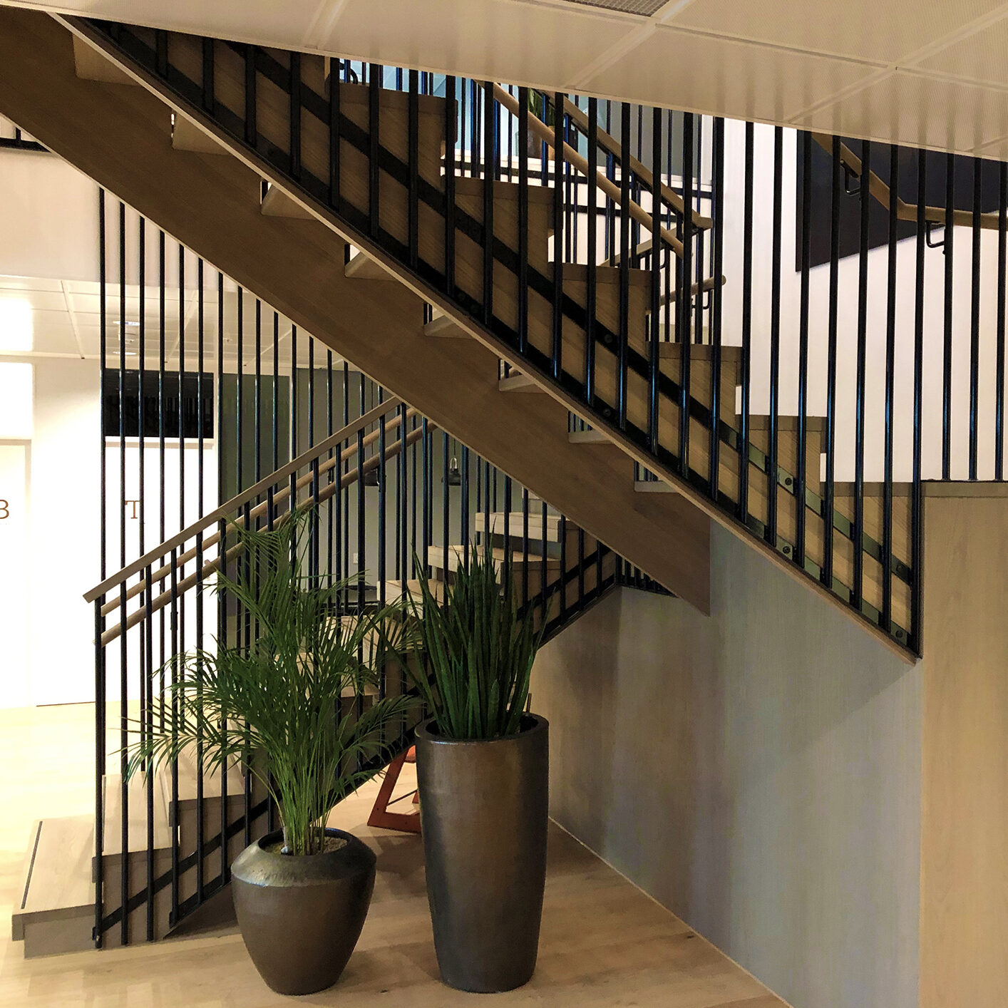 Modern steel staircase with wooden steps in a new apartment in a residential building